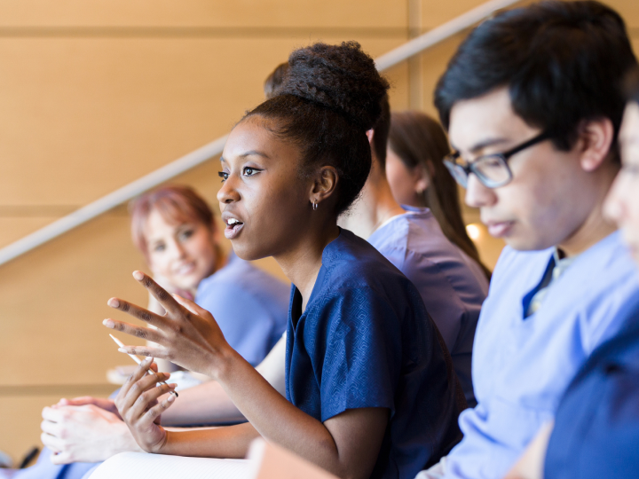 student asking a question in a lecture hall
