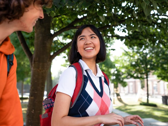 two students walking to class together outside