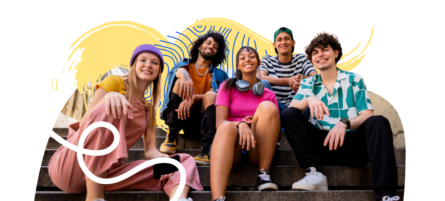 Group of students sitting on steps and smiling