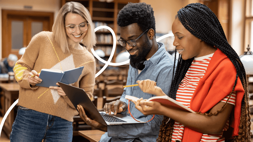 Three students studying and reviewing notes