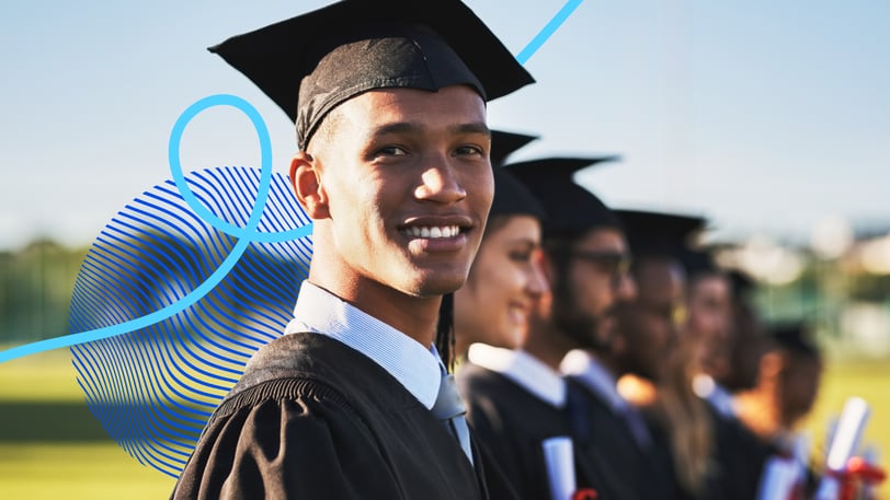 Young college graduates in caps and gowns celebrating graduation during a commencement ceremony outdoors.