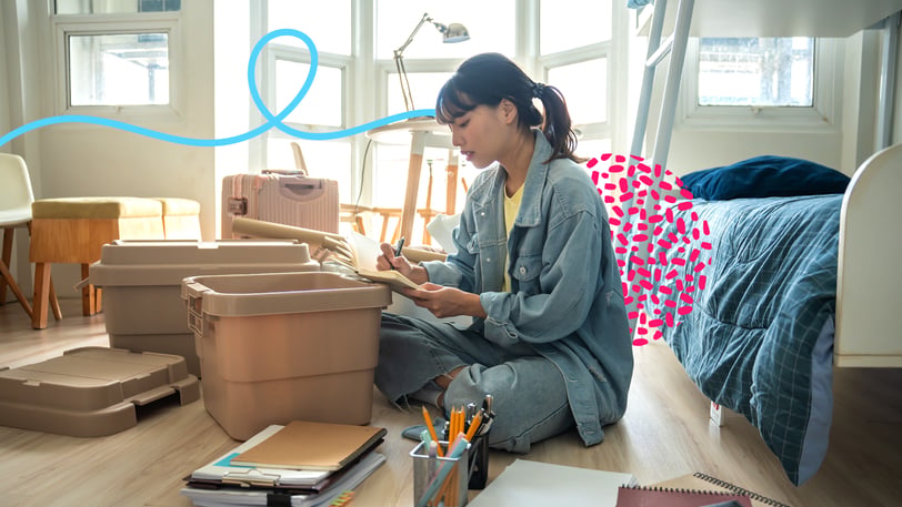 College student sitting on the floor of a dorm room surrounded by storage bins and school supplies while planning move-in, with colorful graphic accents illustrating the financial planning and budgeting challenges associated with preparing for college.
